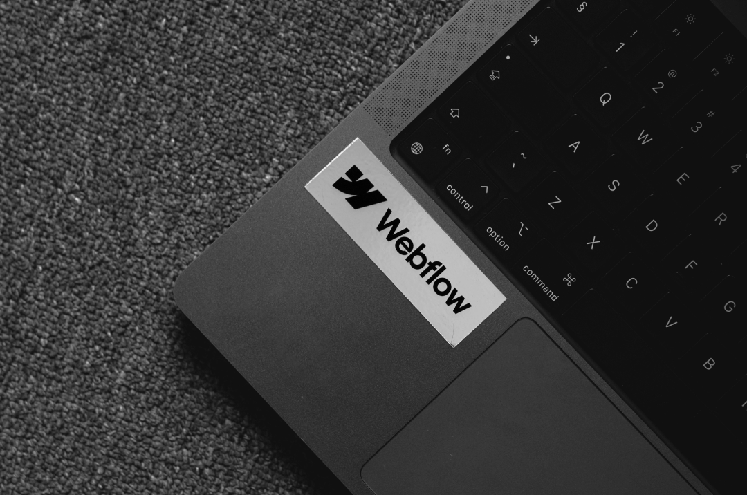 Webflow sticker on a laptop, fueling the energy behind standout web animations.