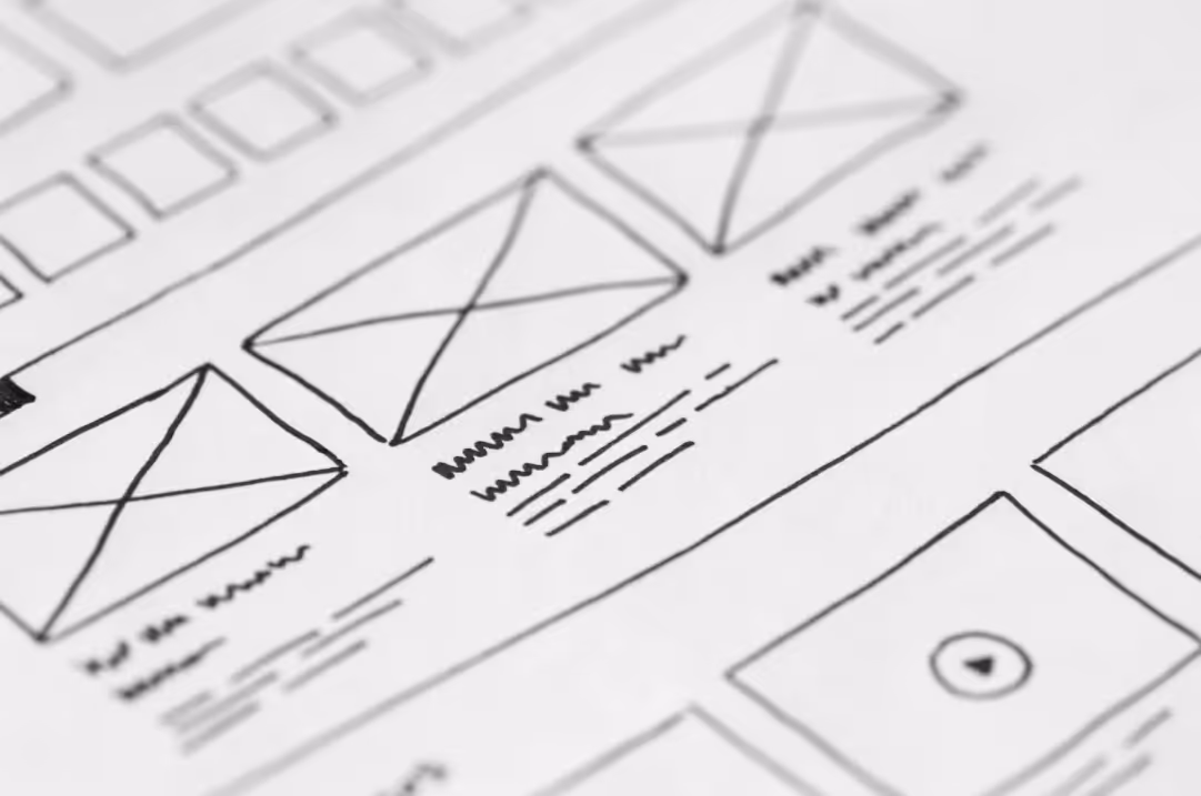 A hand drawn wireframe on a piece of paper.