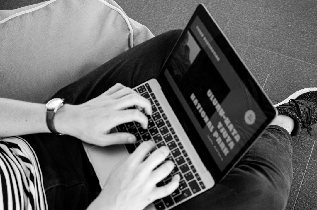 Designer working on a laptop while reviewing modern B2B web design trends.