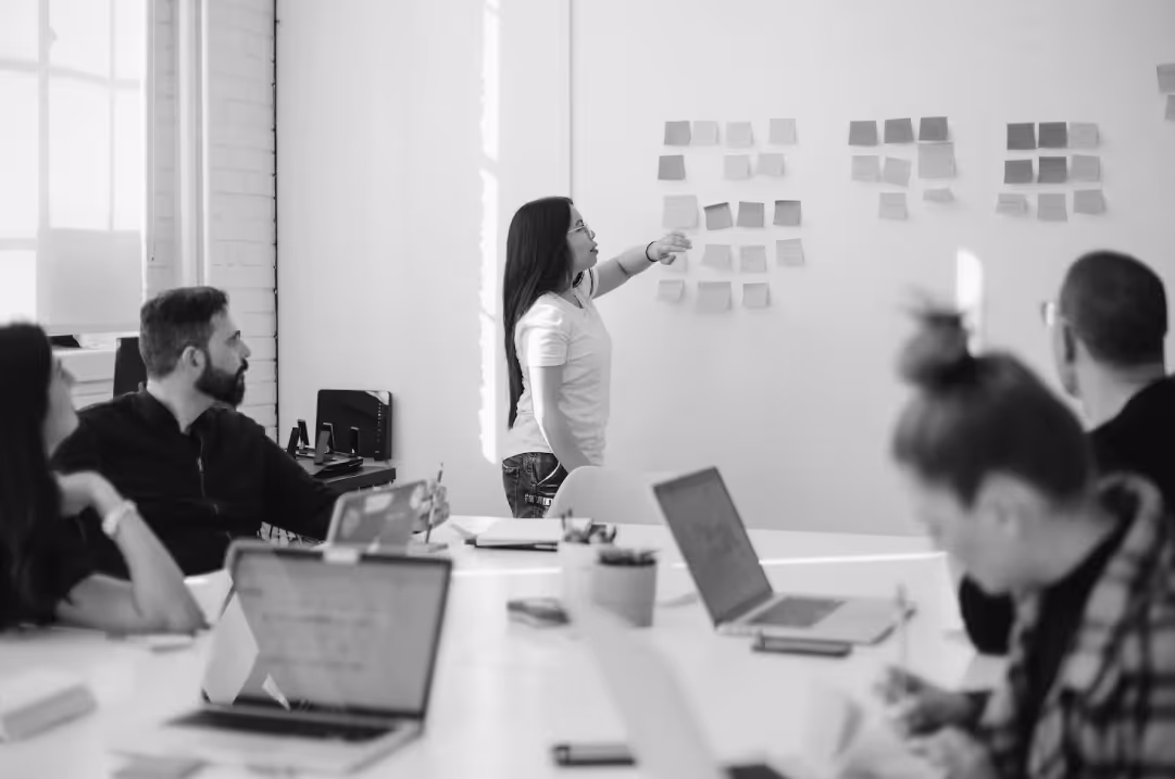 Team reviewing and organizing brand messaging on a whiteboard.
