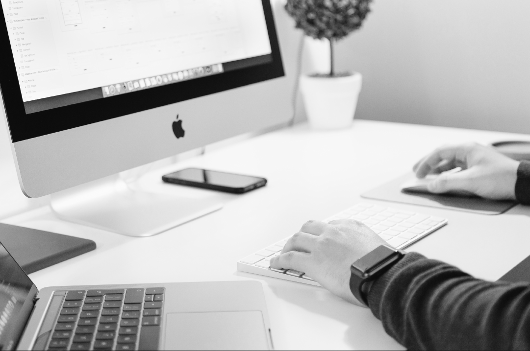 Designer working on brand assets at a computer workstation.