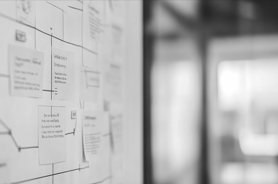 UX research workflow with sticky notes and user journey mapping on a whiteboard.