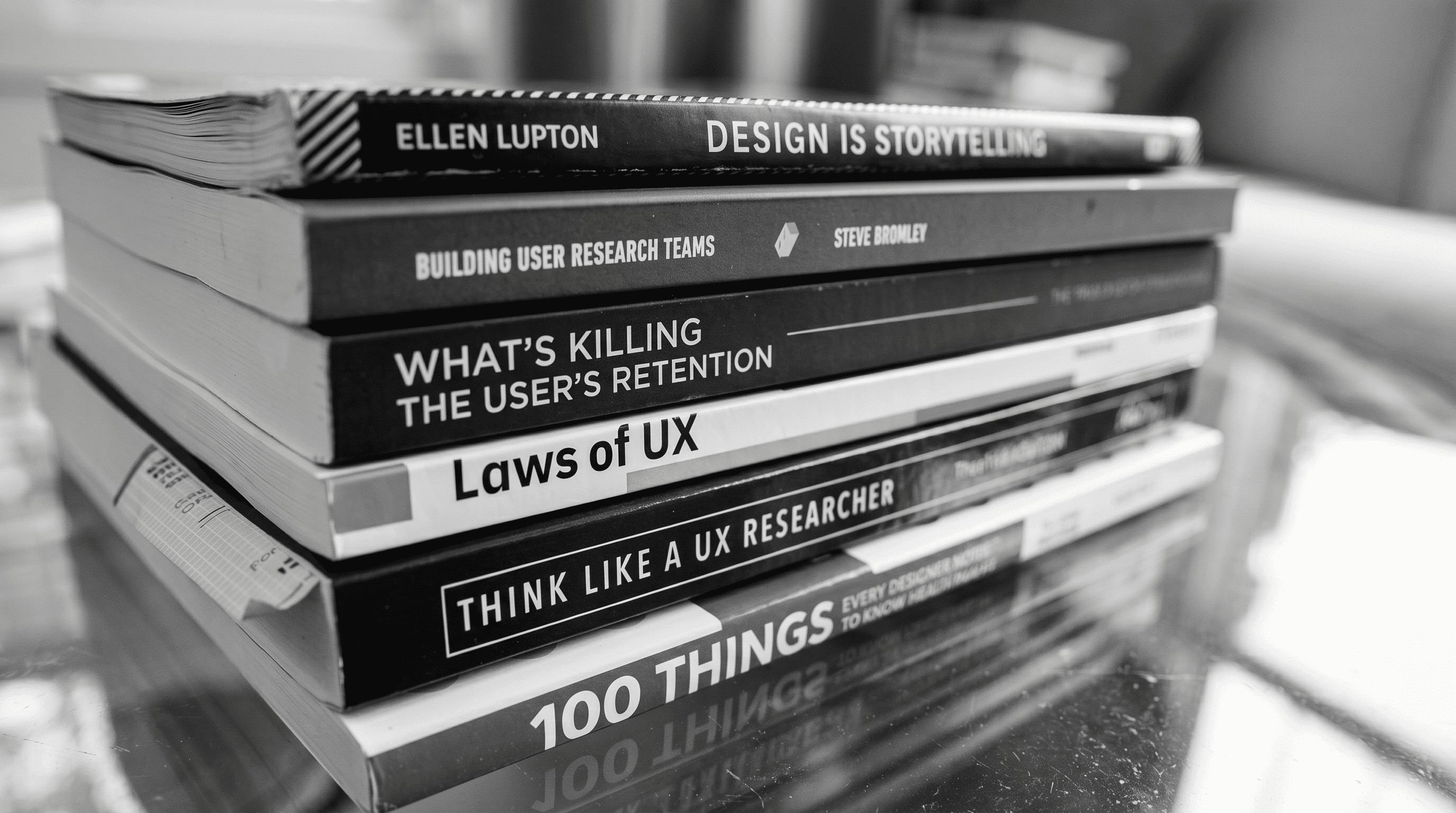 Stack of UX and product design books including Laws of UX and Design Is Storytelling