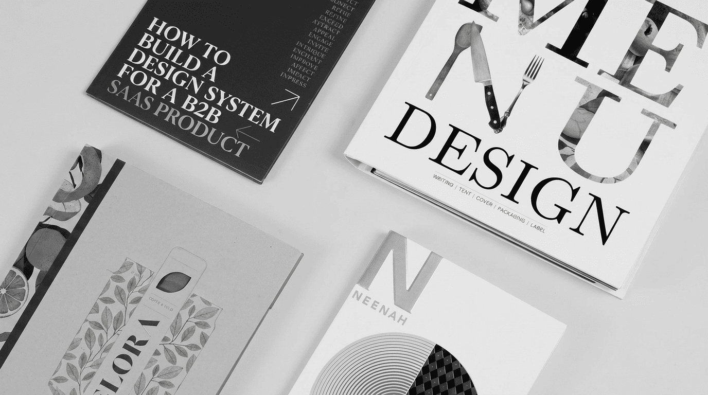 Design system publications and brand guides spread on a flat surface