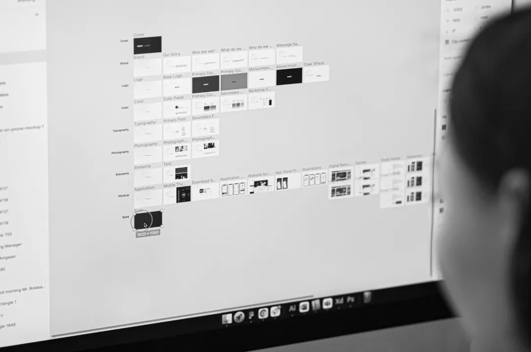 Person designing a brand system on a computer screen.