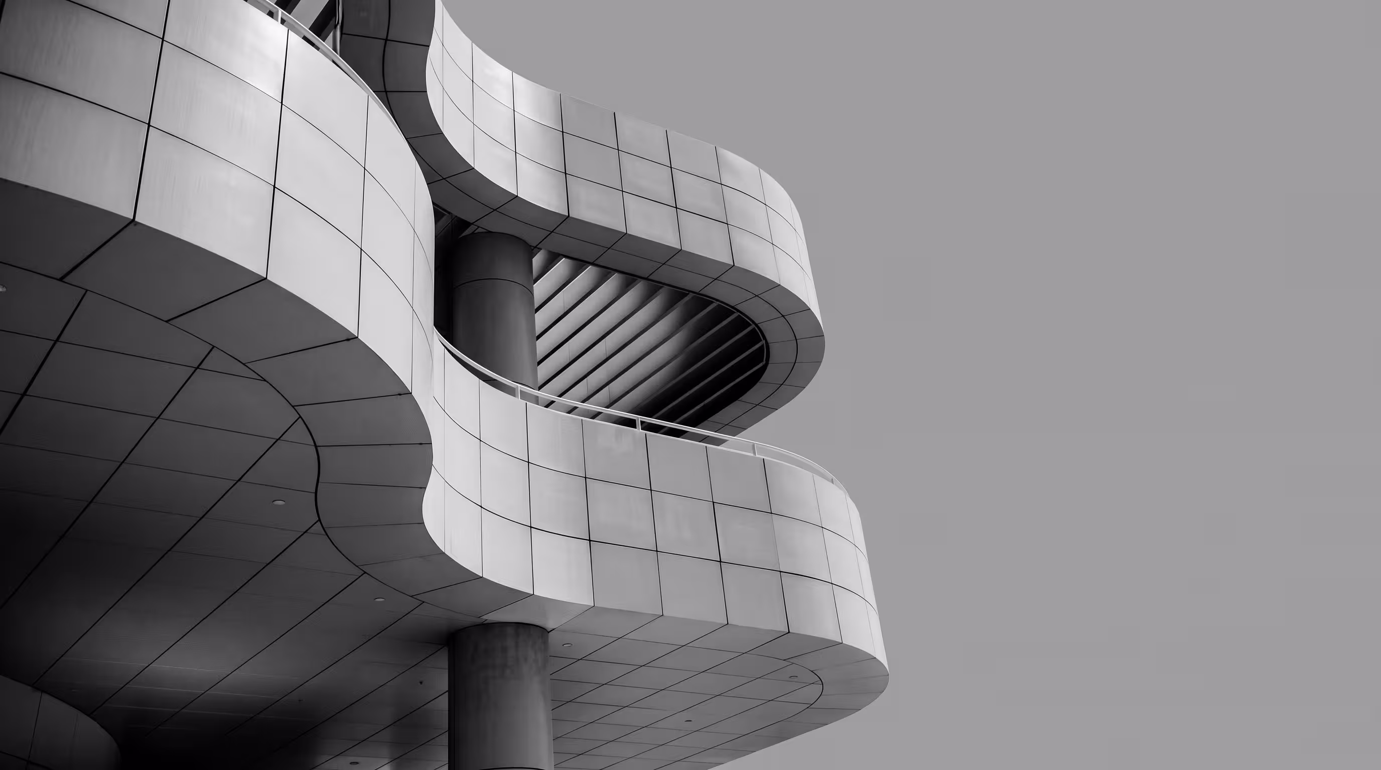 Modern building exterior with curved, tiled metal cladding