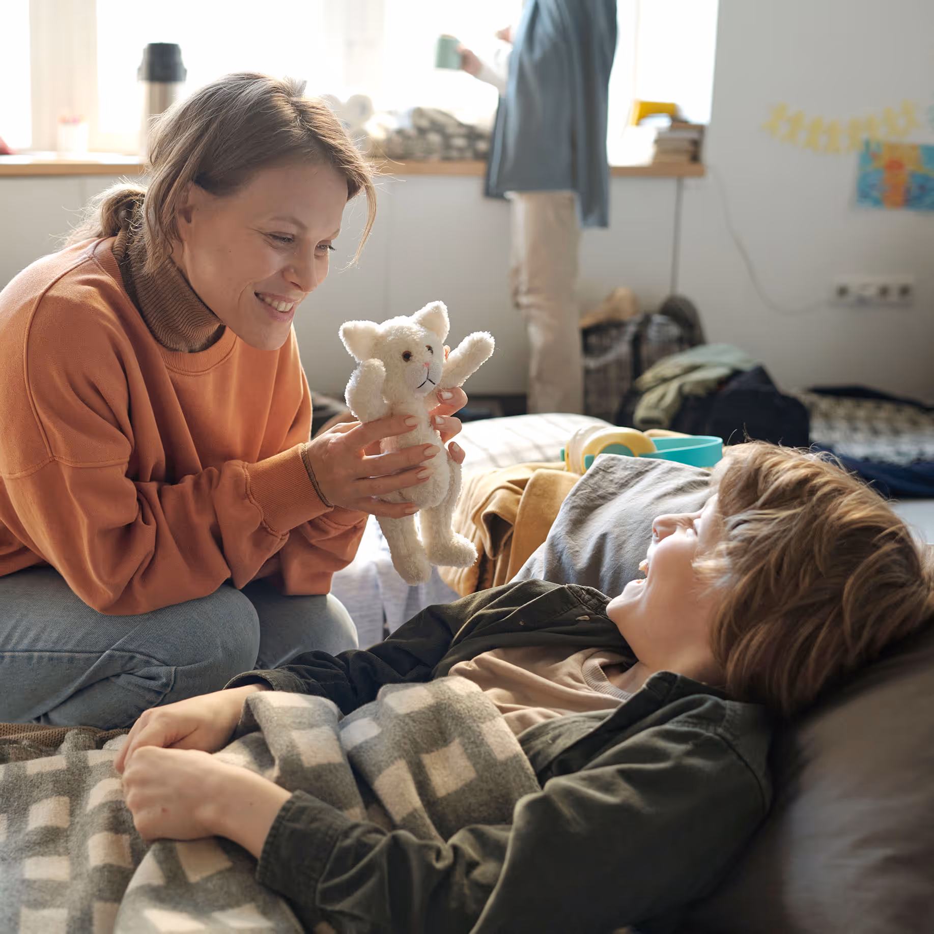 A mom comforting her son in an emergency shelter