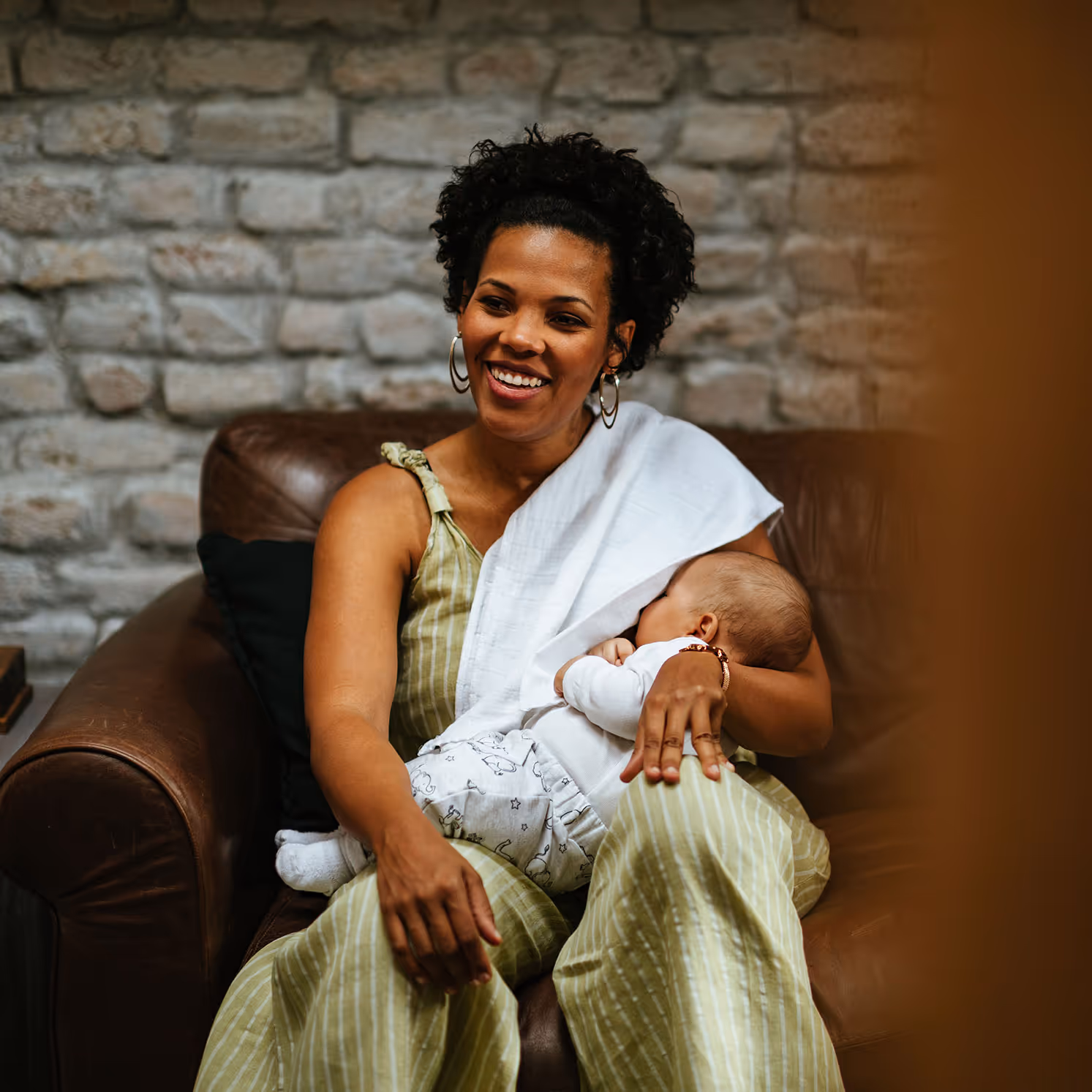 A woman nursing her newborn baby