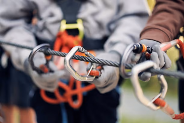 Close up of carabiners and fall arrest connectors attached to a safety line ready for inspection
