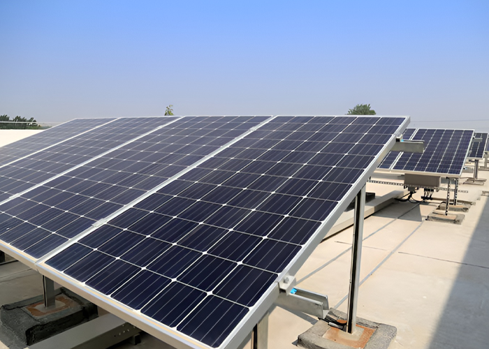 Tilted solar panels on a flat rooftop with concrete ballast footings