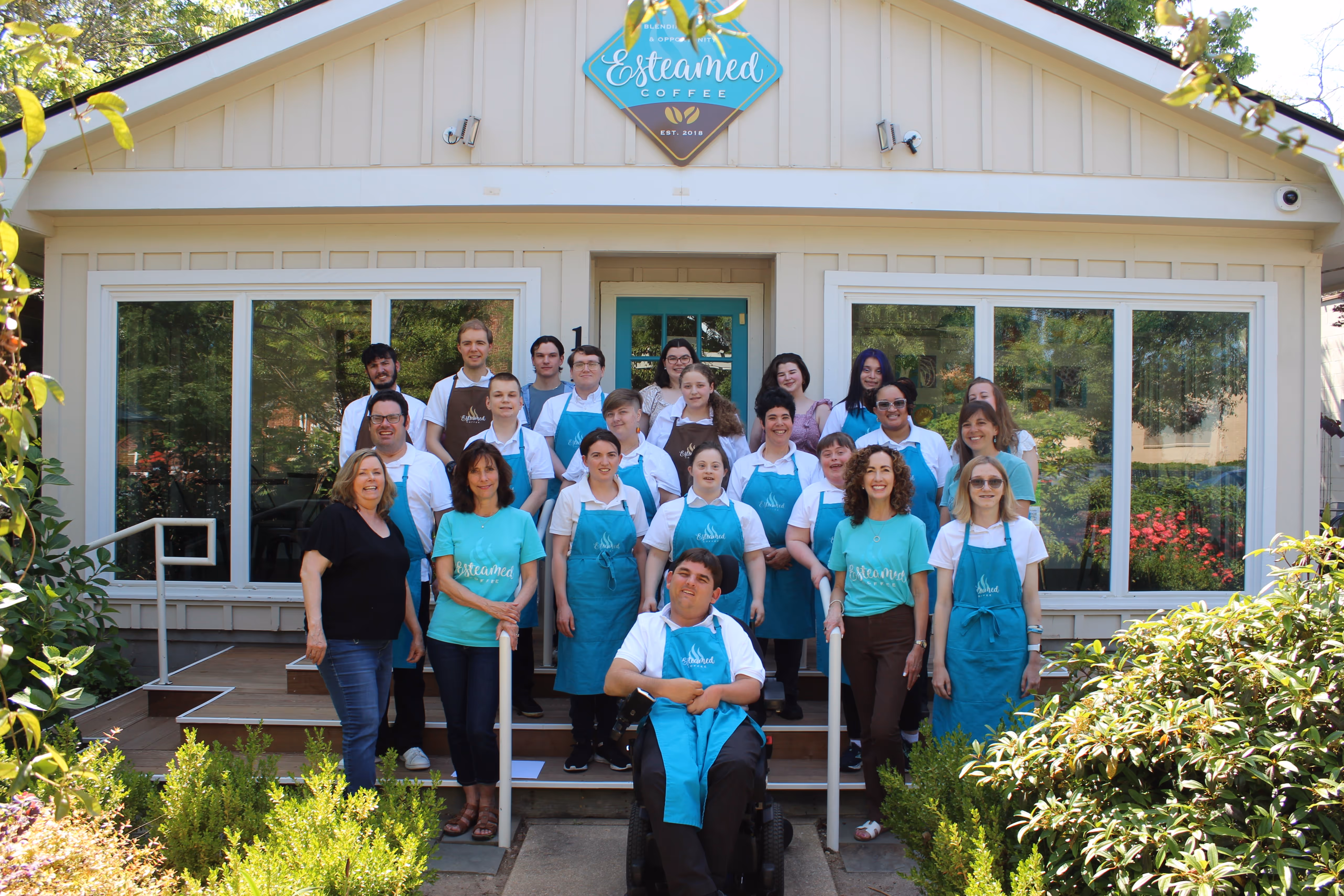 The whole staff in front of the shop