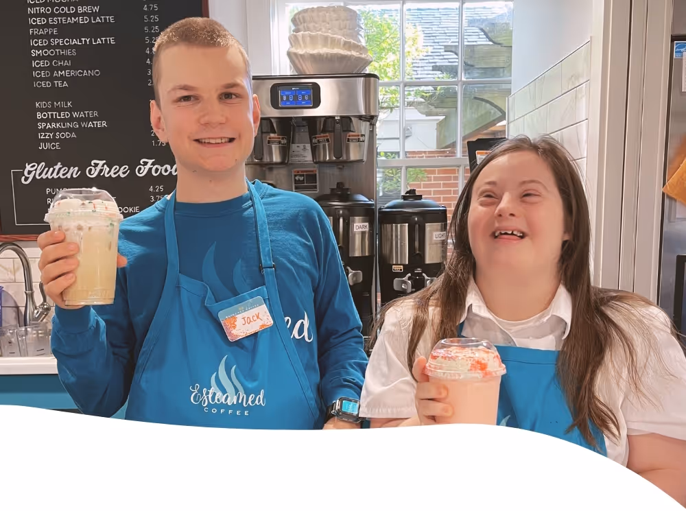 cashier Jack, and barista Molly smiling and holding a drink