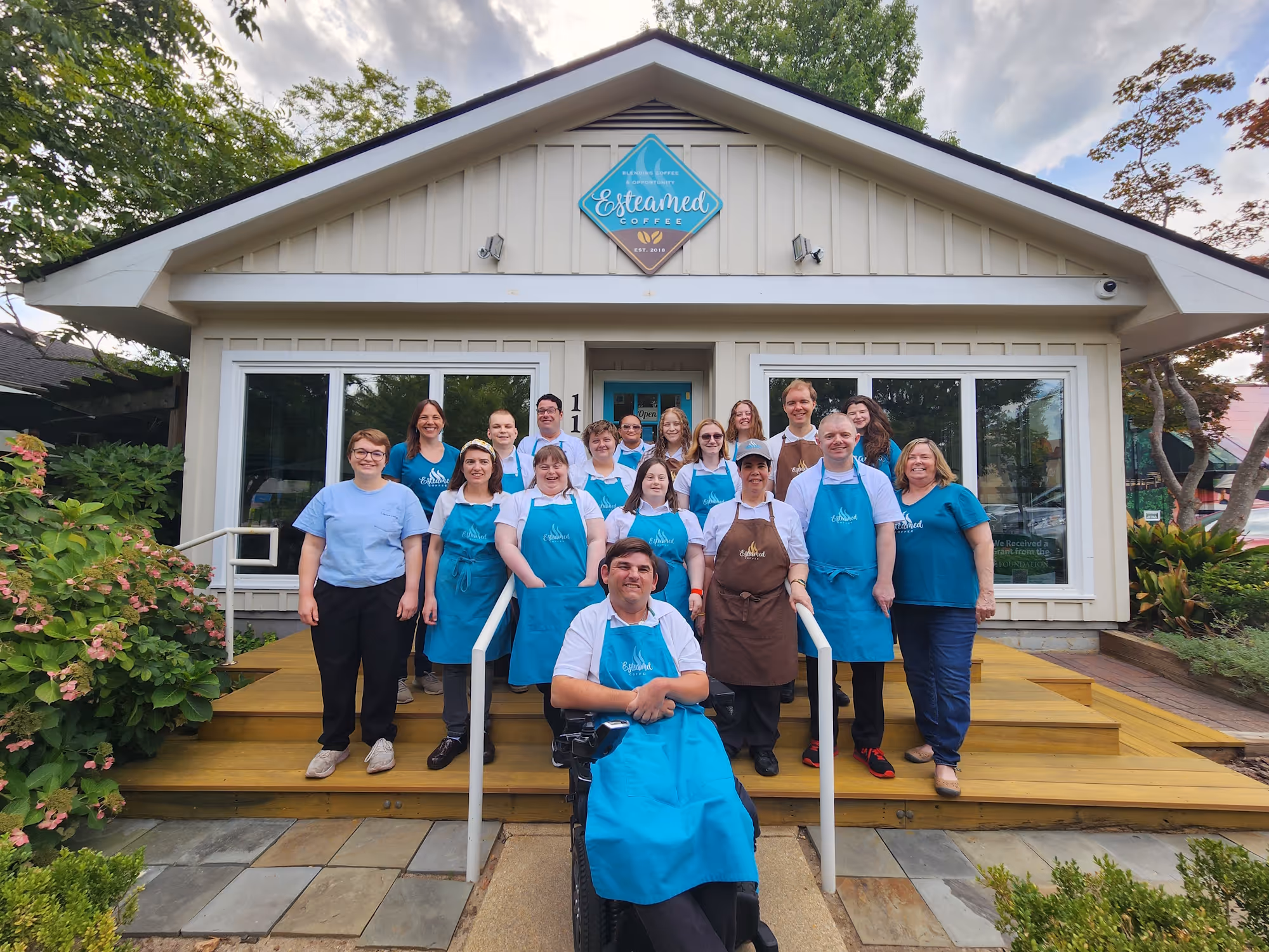The whole staff posing in front of Esteamed Coffee