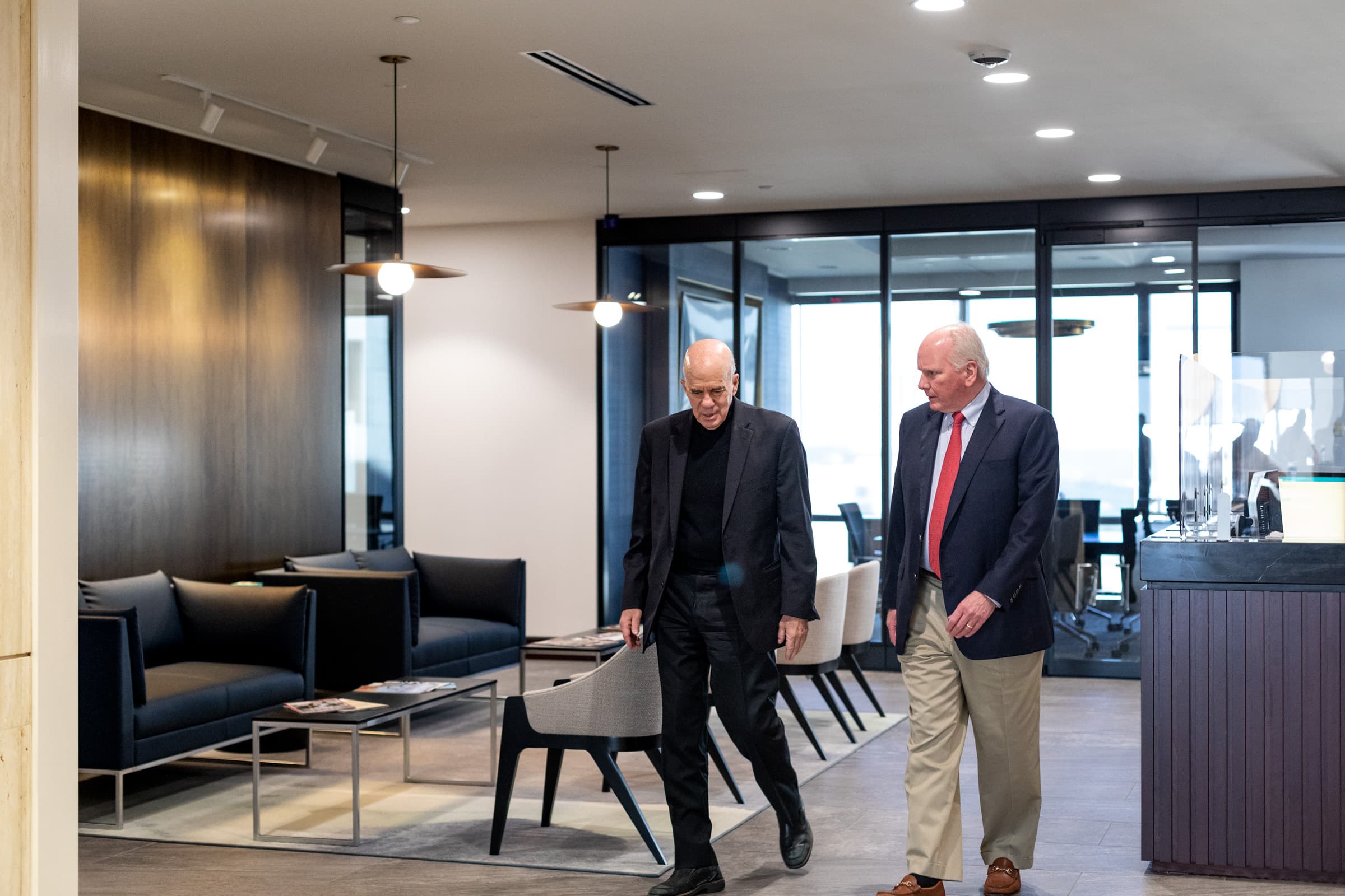 A lawyer consulting with a client while sitting at a table.