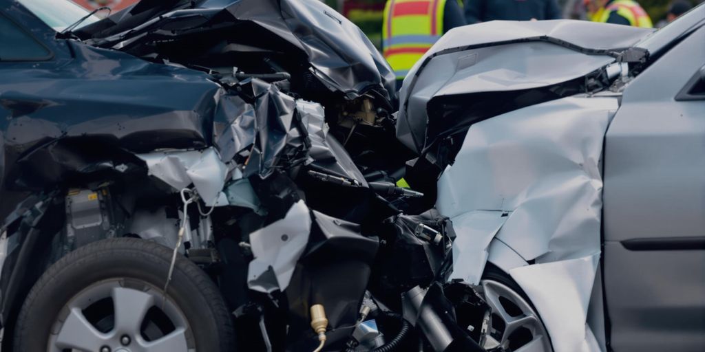Photograph of a car accident with damaged vehicles.