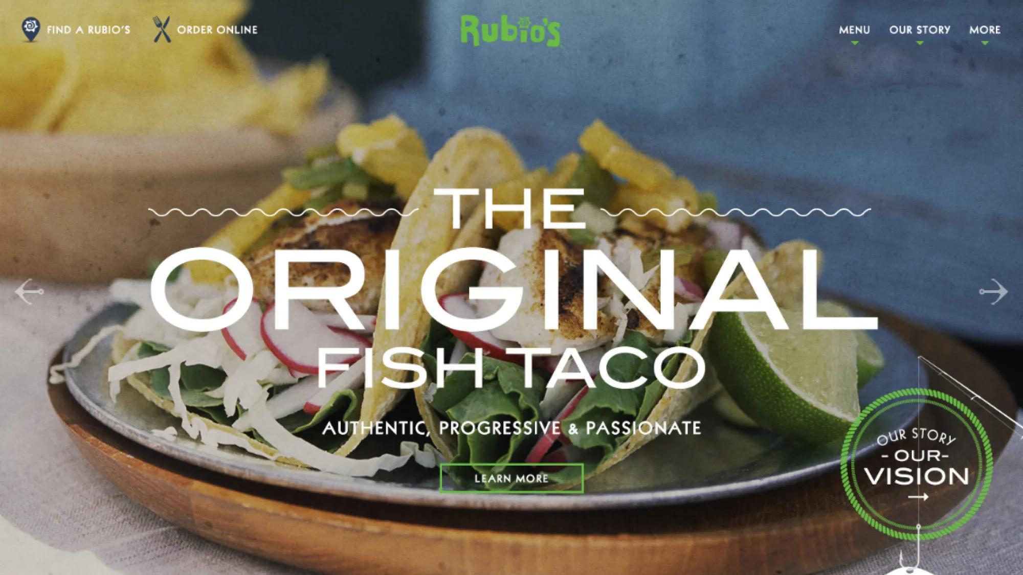 Plate with two original fish tacos garnished with lime wedges and fresh vegetables.