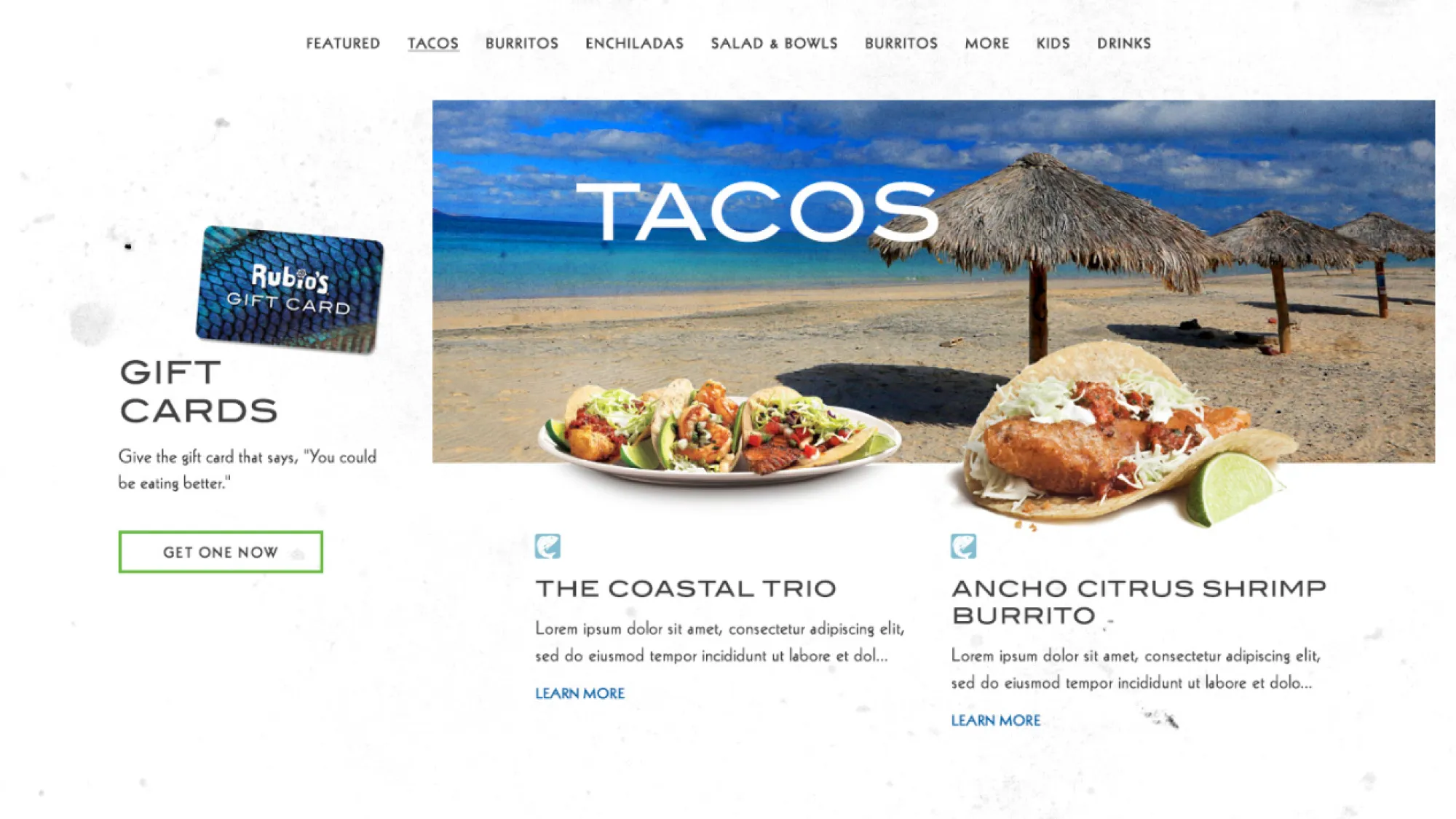 Plate of three tacos with seafood and vegetables on a sandy beach with thatched umbrellas and blue sky in background.