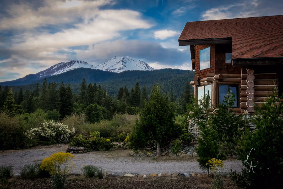 A house with a mountain in the background.