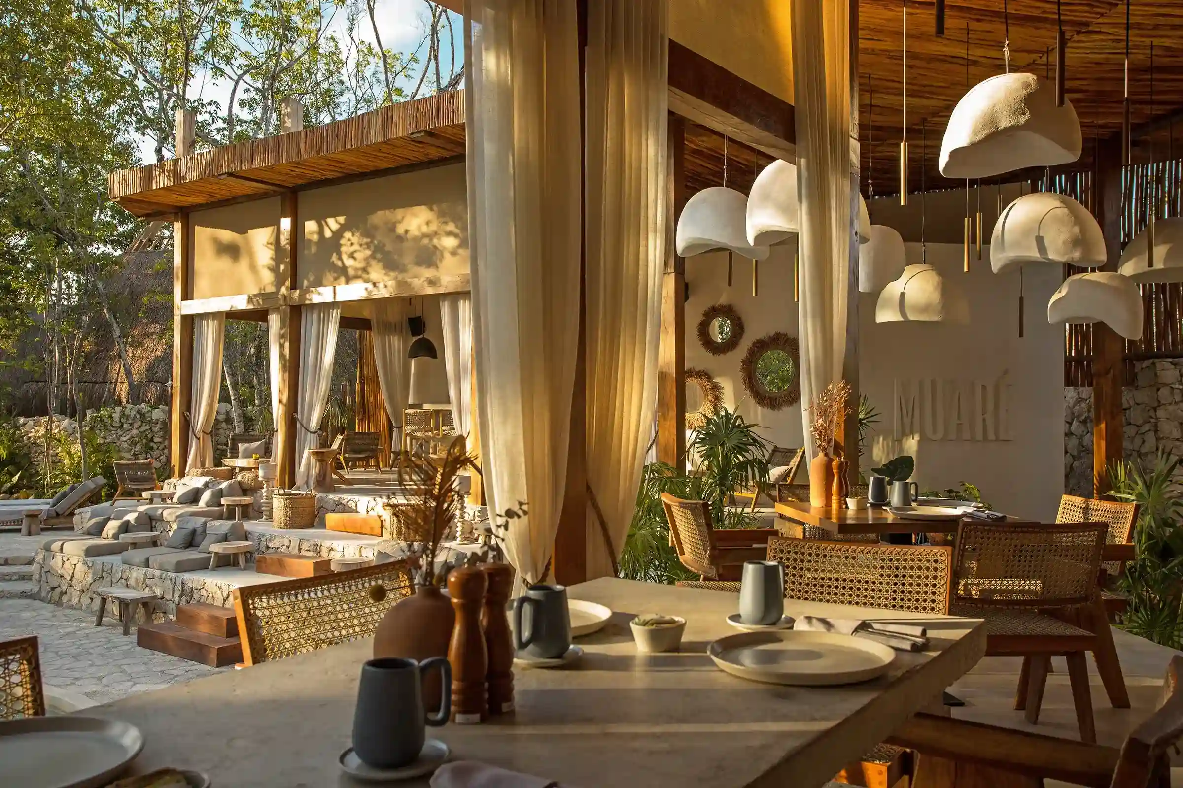 restaurante-mesa-sillas-lamparas-flotantes-cortinas