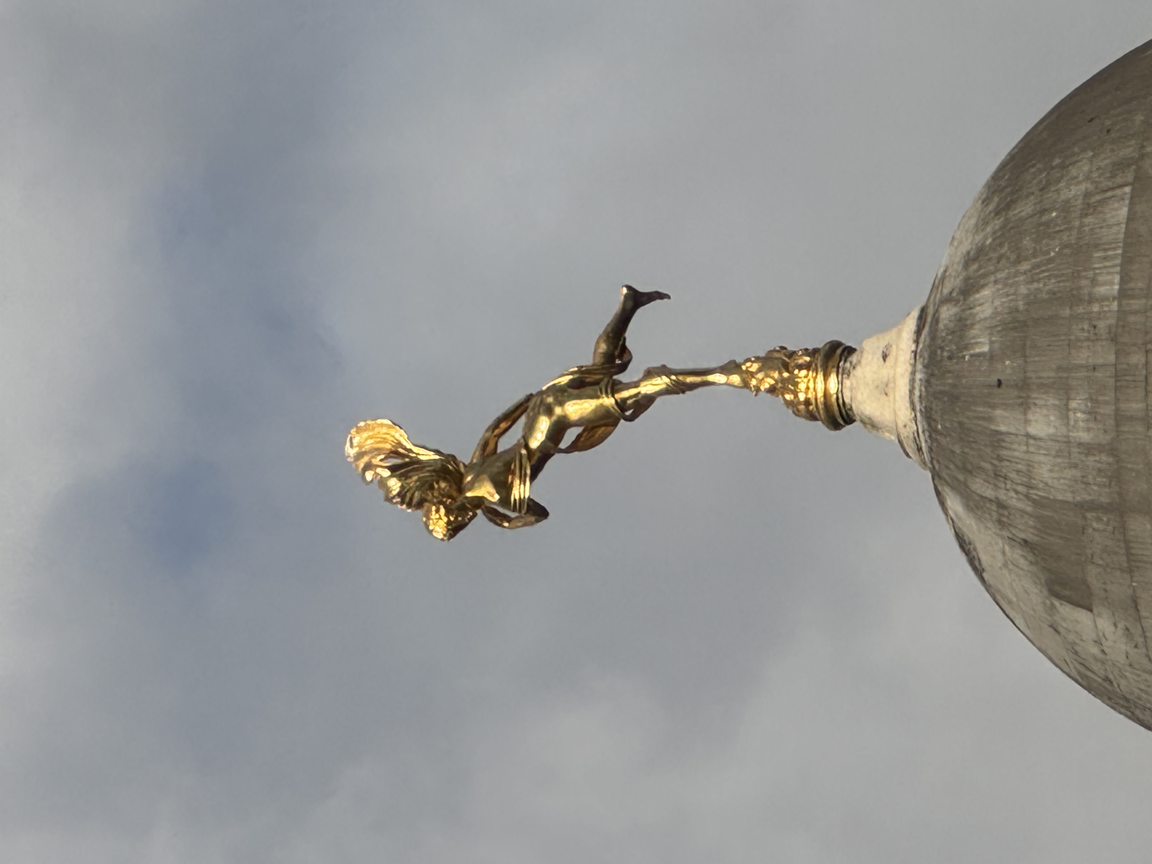 Gilded figure against the sky in the City of London