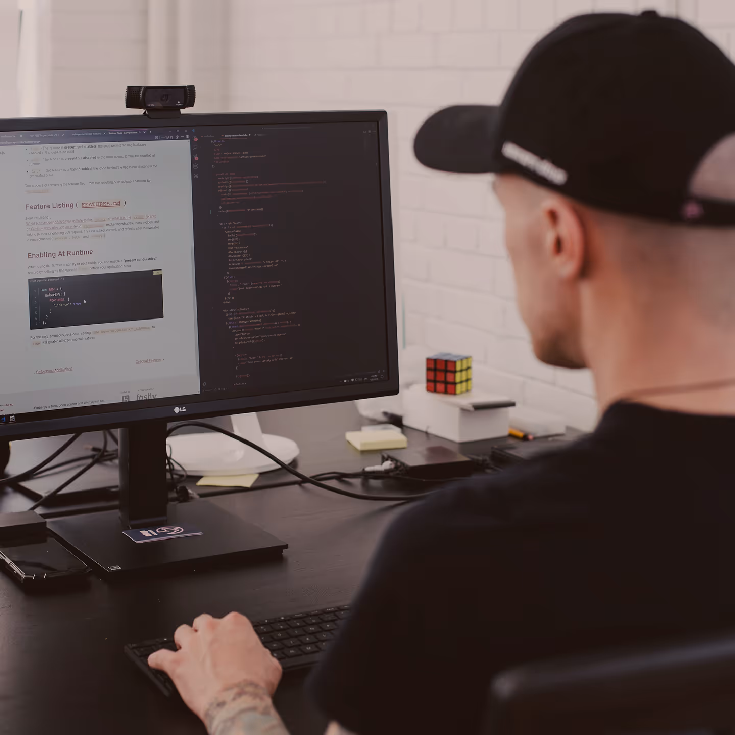 Photograph of a man working at a computer shot from behind