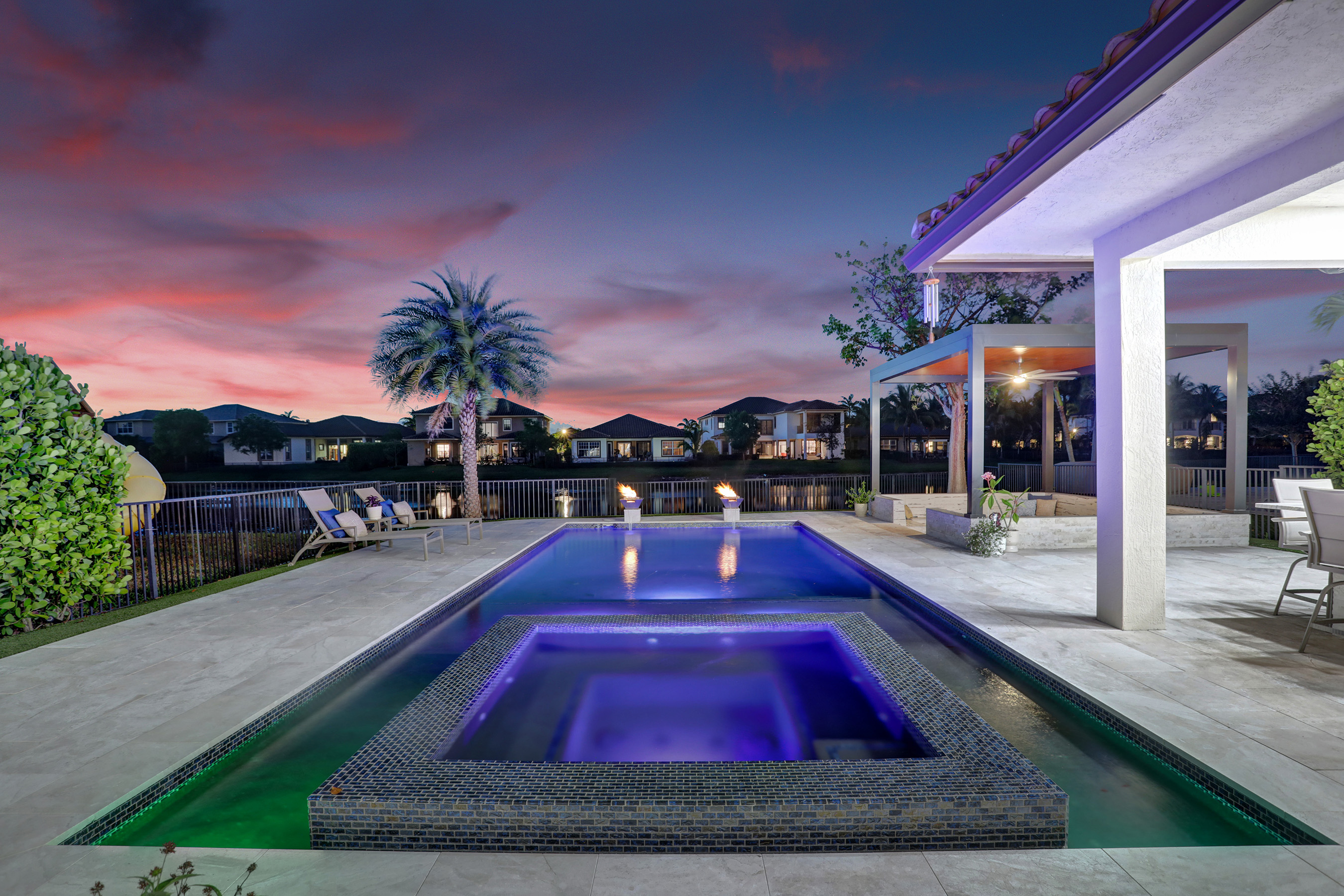 Twilight real estate photo of a South Florida pool and spa at dusk