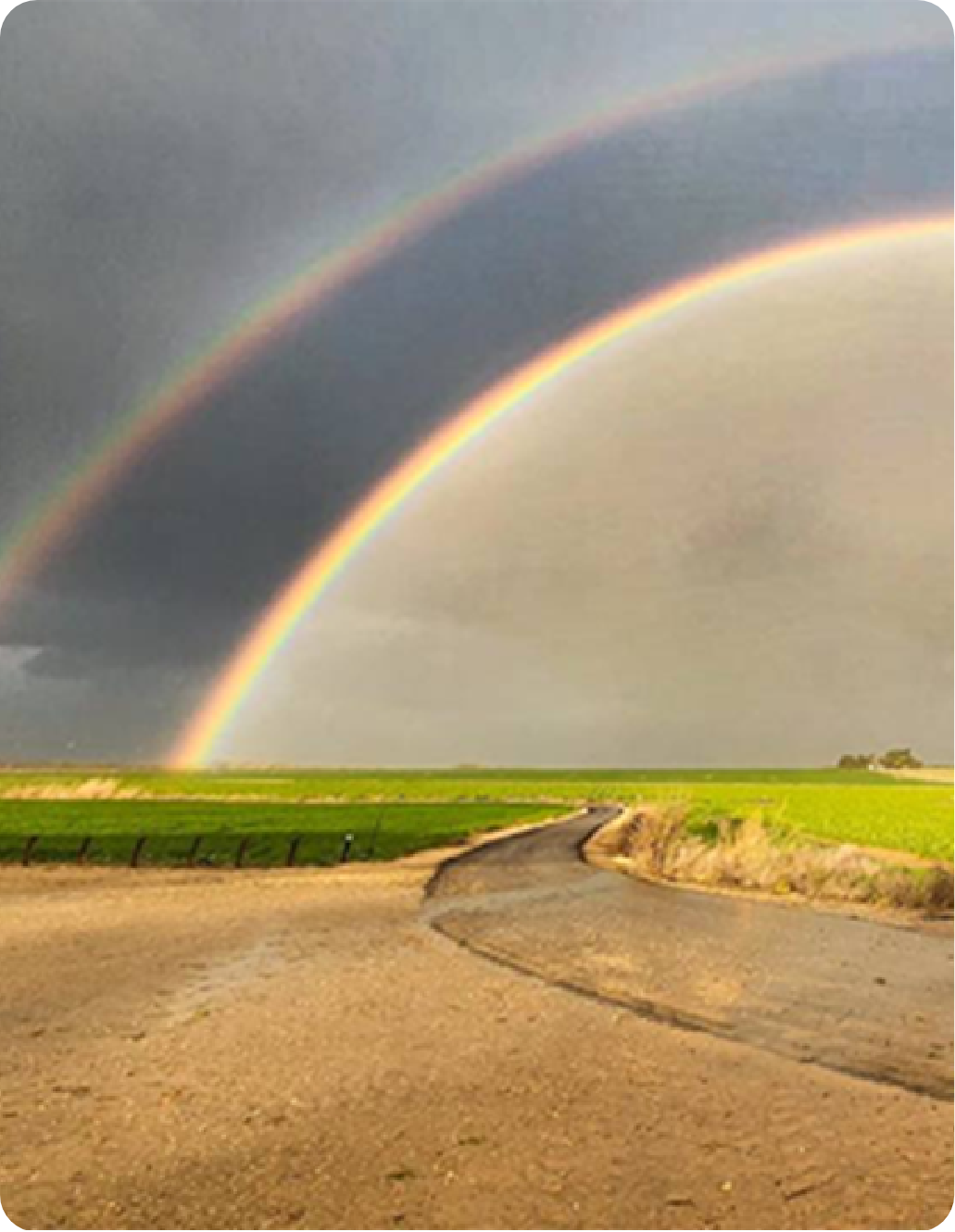 Double rainbow arching over Kibbutz Be'eri fields.