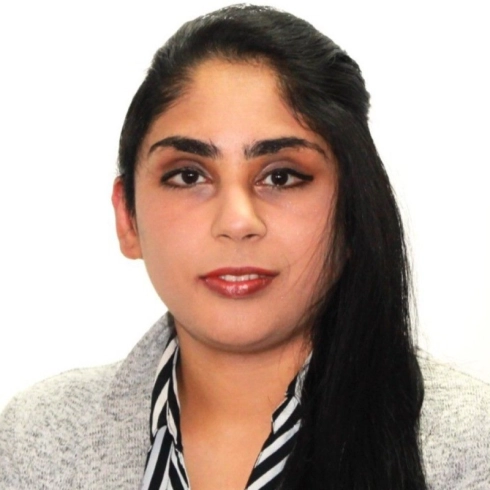 A Woman With Long Black hair upto neck looking at camera