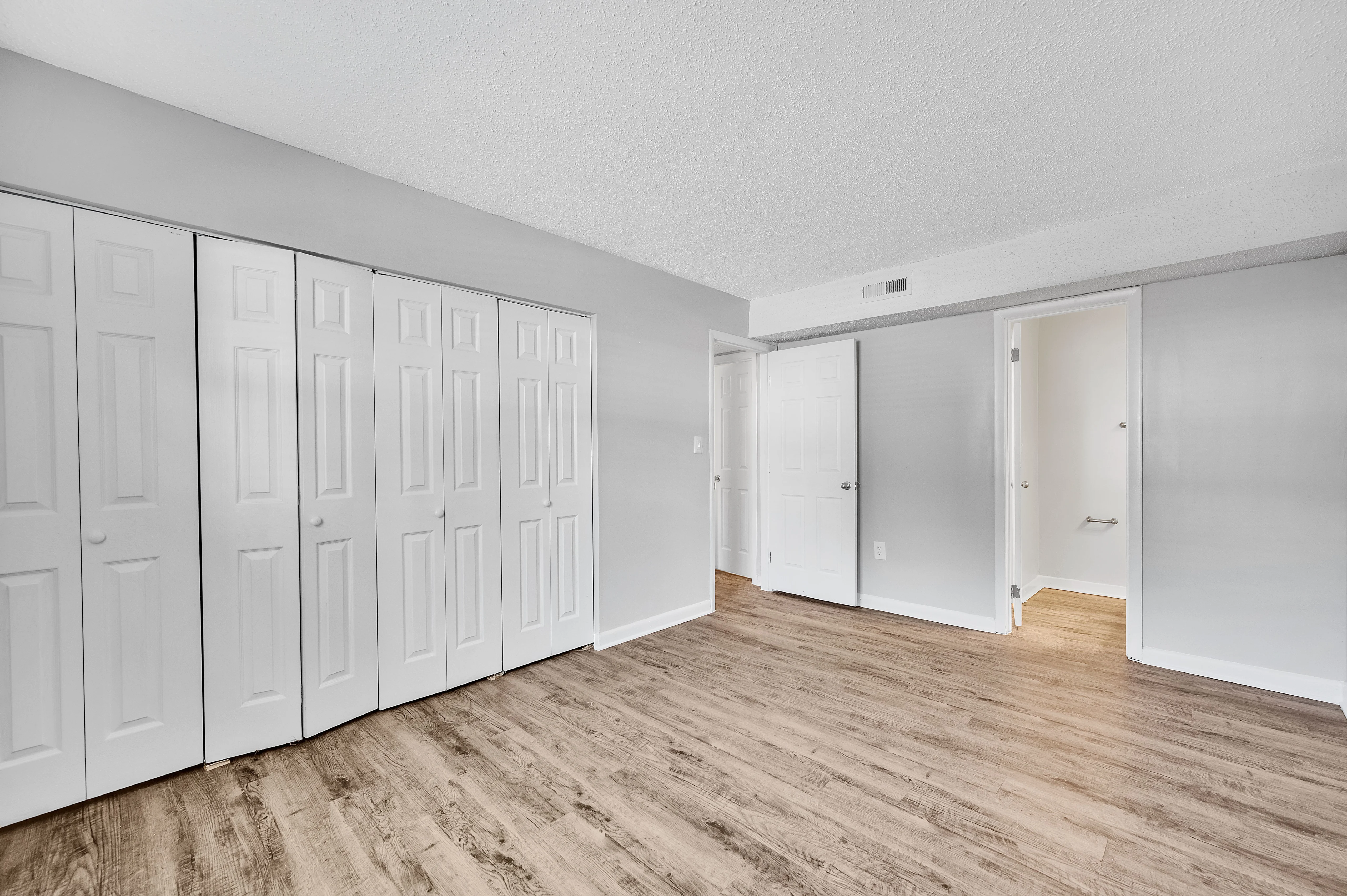 Room with wood floors and open closet