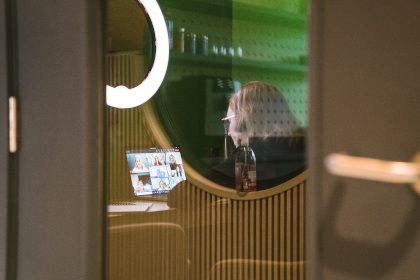 Person on a video call with colleagues in a phone booth at Plus X Brighton