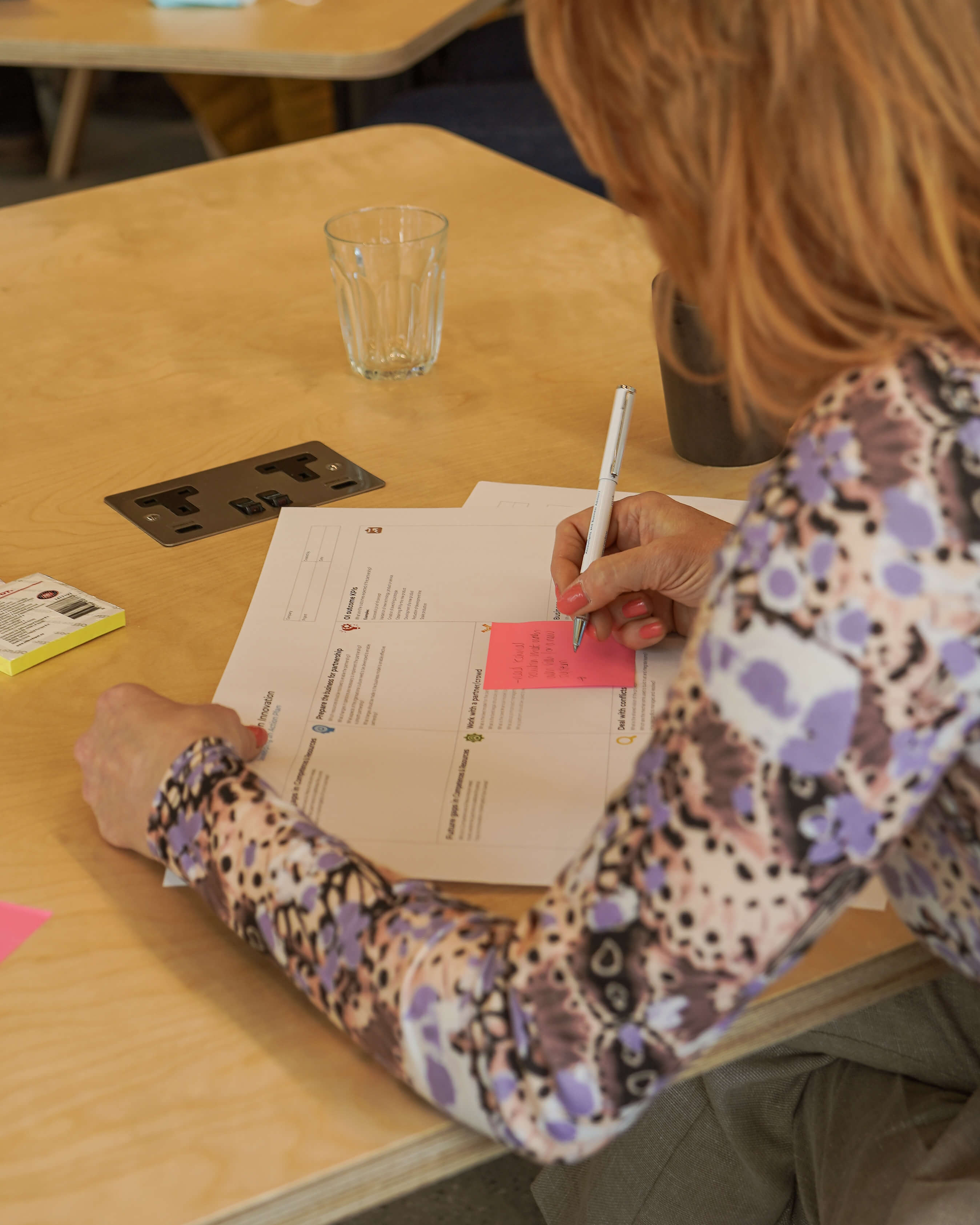 A person writing down notes for a business