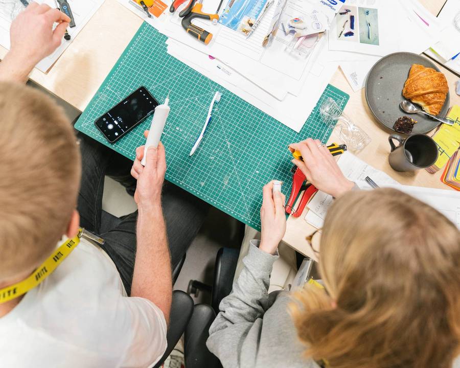 Two people working together in the workshop at Plus X Innovation Brighton