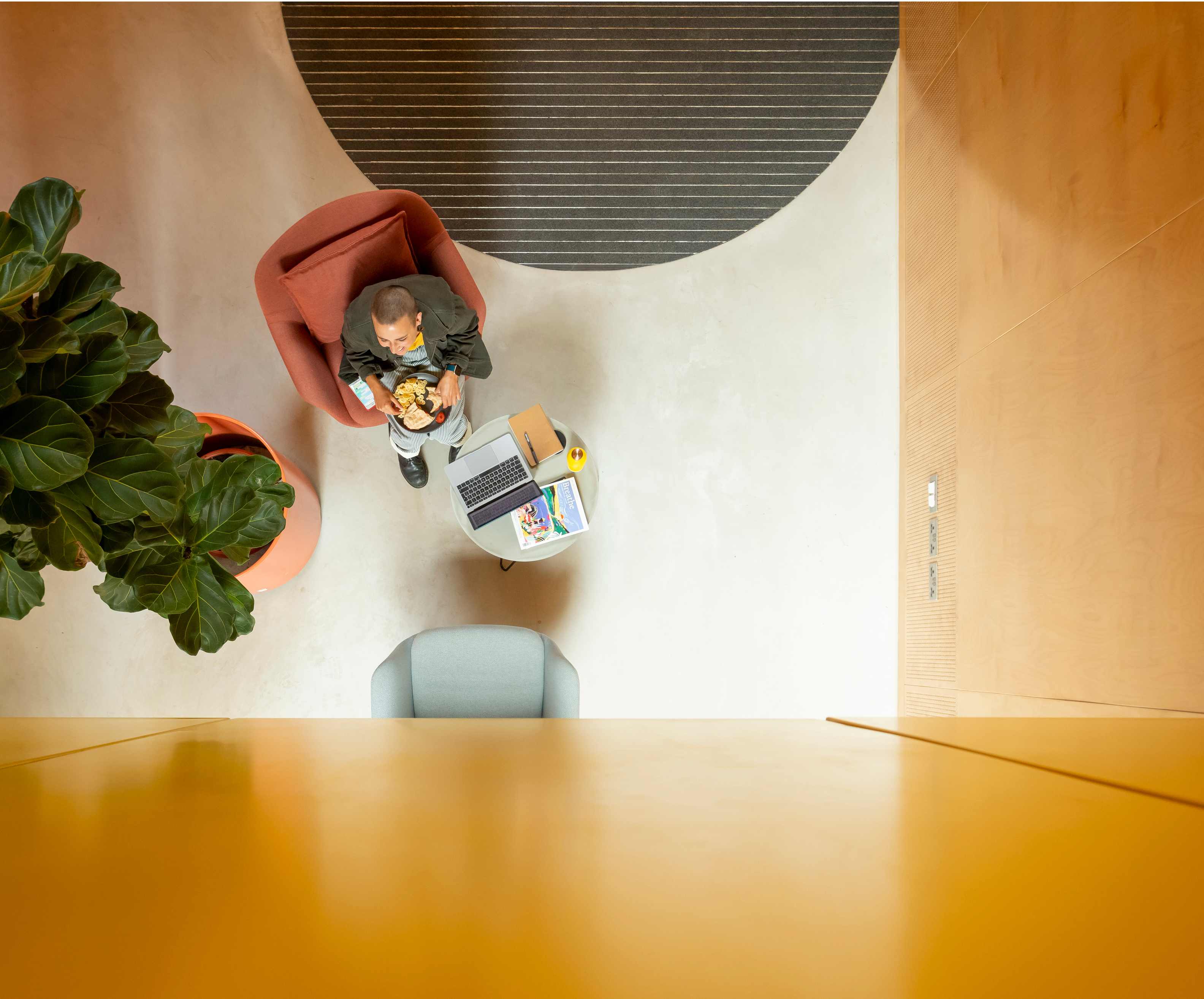 Coworker from above working at a desk in Plus X Brighton