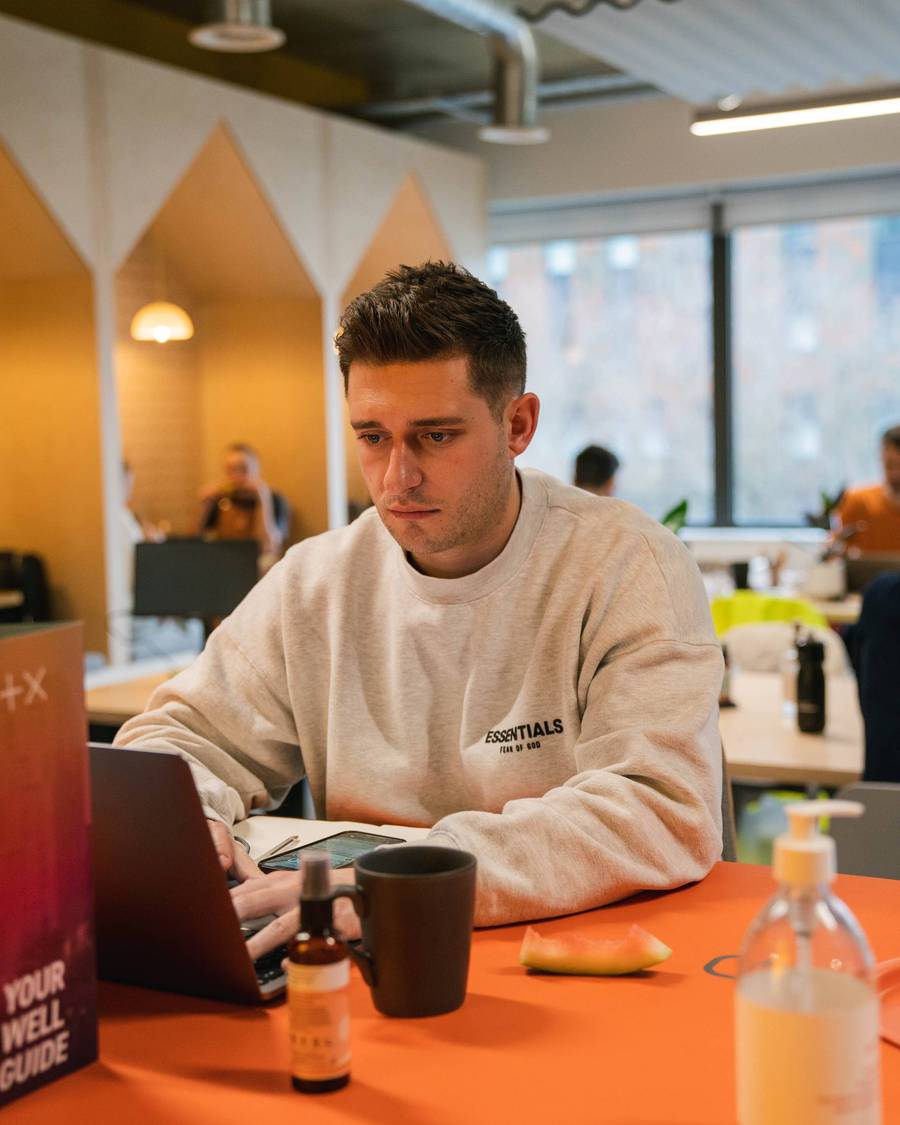 A Plus X Innovation member working on their laptop