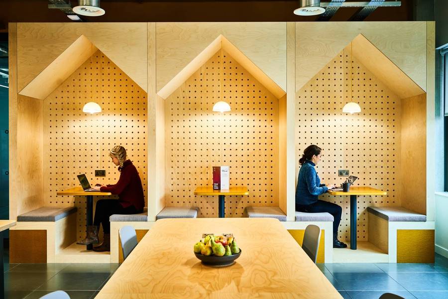 Members working in a shared workspace at Plus X Innovation Brighton