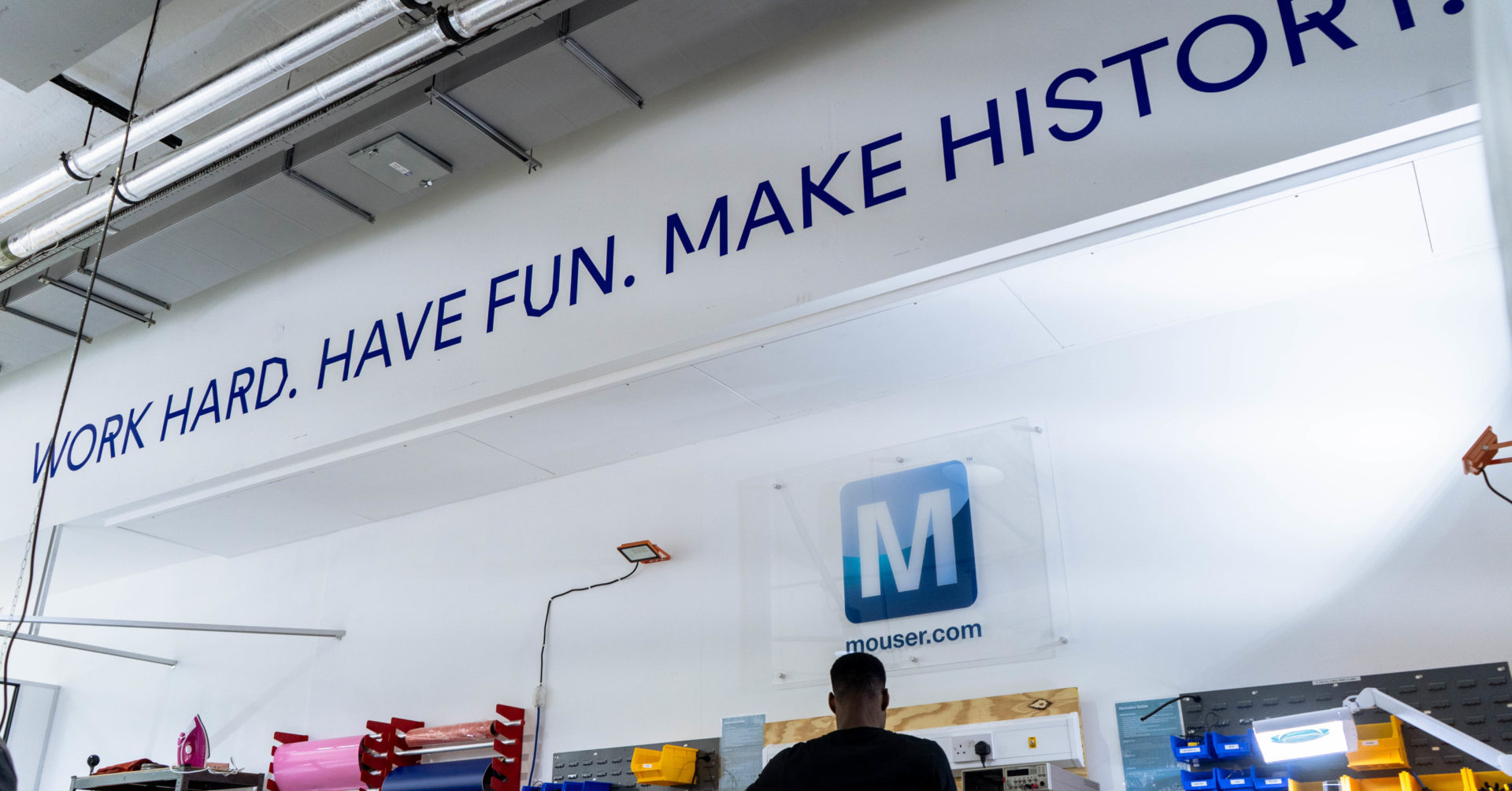 "Work hard, have fun, make history" sign in the the West London workshop