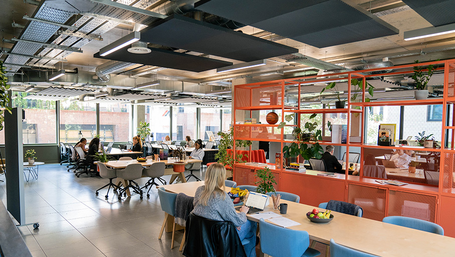 a woman sitting at a desk with a laptop