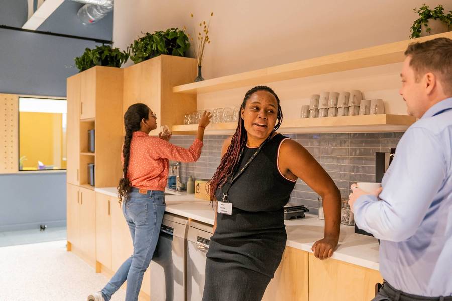 Plus X Innovation members in the Slough ground floor kitchen.