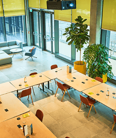 An event layout in the Launch Space consisting of a semi-circle of tables and chairs