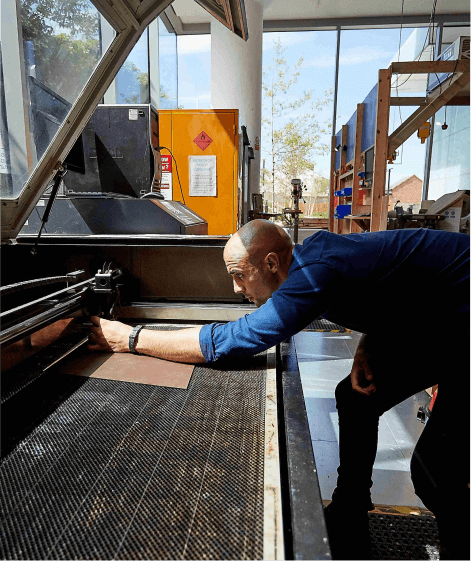 Man working on machine in heavy workshop