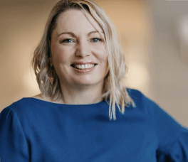 white woman with shoulder length blonde hair smiling at the camera 