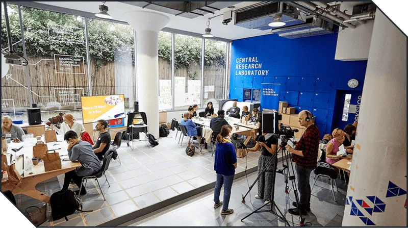 An event taking place in Central Research Laboratory including a camera crew interviewing coworkers