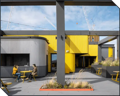 Two coworkers enjoying the rooftop bar at Plus X Innovation Brighton