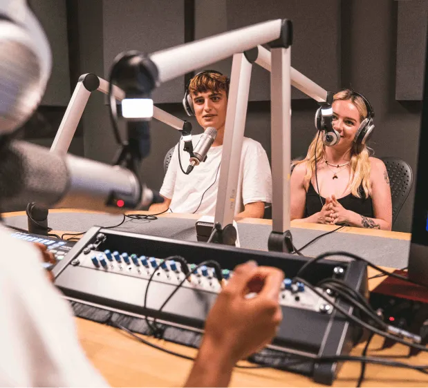 Two people being interviewed in the podcasting suite at Plus X Innovation Brighton