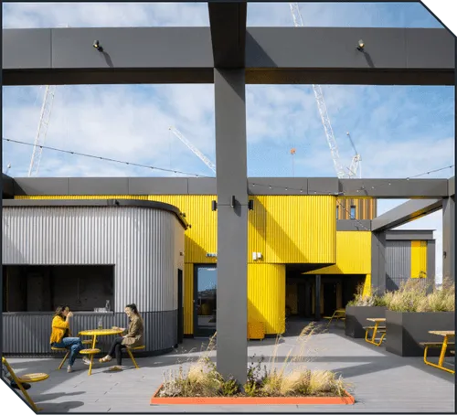 Coworkers enjoying the rooftop bar at Plus X Innovation Brighton