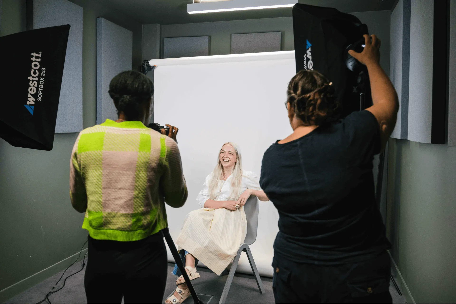 Two people photographing a person in the photography suite at Plus X Innovation Brighton