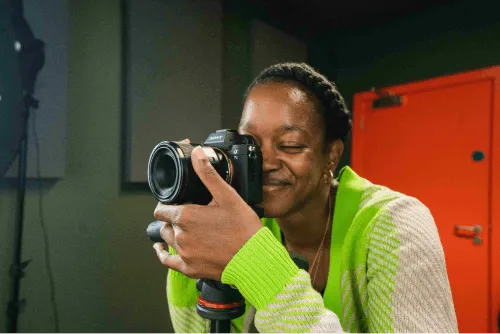 A person taking a professional photo in the photography suite at Plus X Innovation Brighton