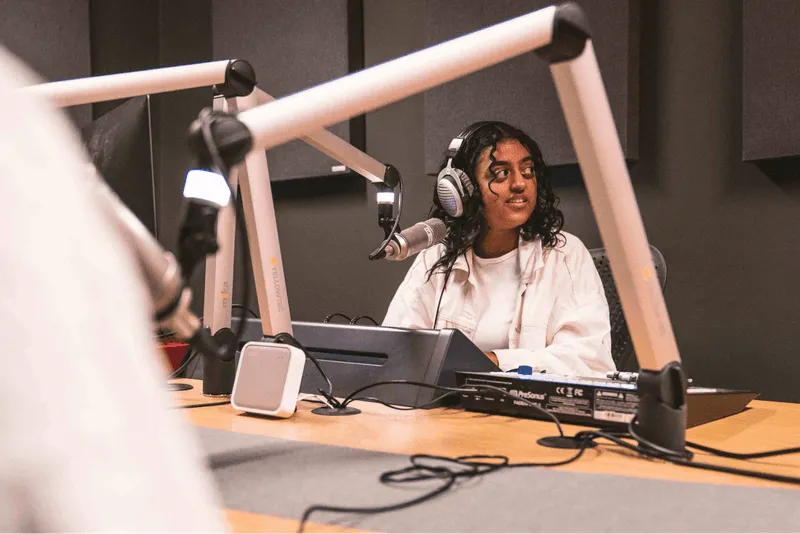 A person using the podcasting suite at Plus X Innovation Brighton