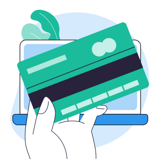 Hand holding a green credit card in front of a laptop with leaves in the background.