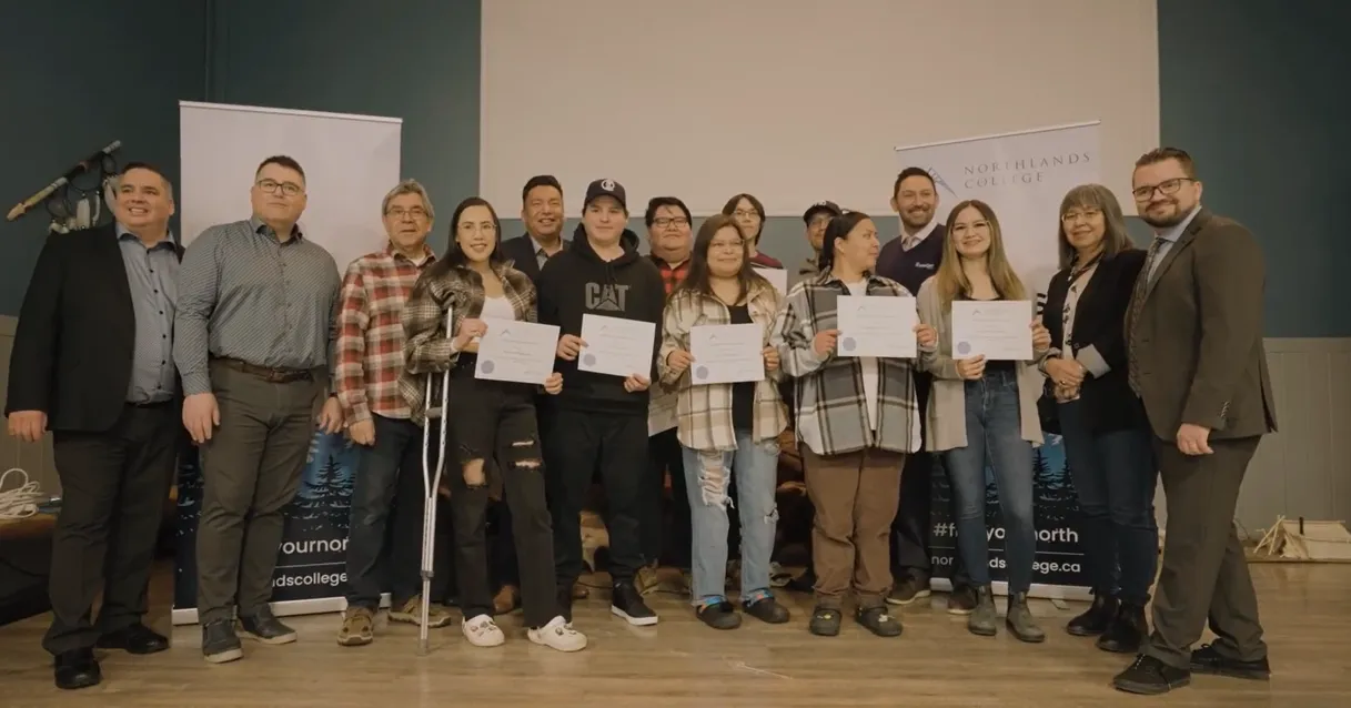 Group of people holding certificates posing for a photo at Northlands College event.